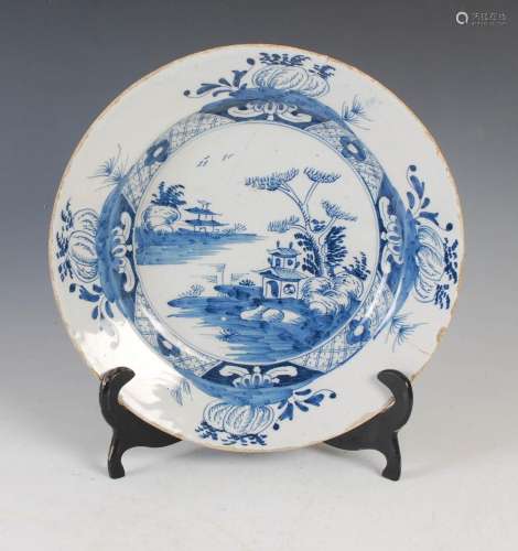 An 18th/ 19th century Delft pottery charger, decorated in th...