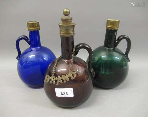 Group of three 19th Century glass decanters in green, blue a...