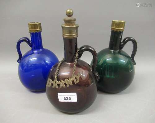 Group of three 19th Century glass decanters in green, blue a...