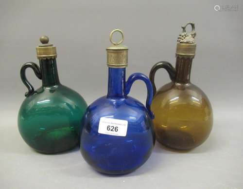 Group of three 19th Century glass decanters in green, blue a...