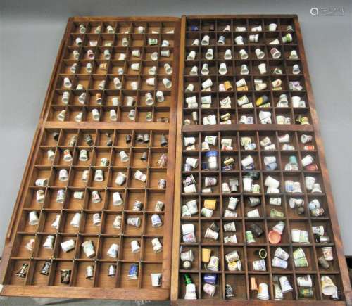Large quantity of ceramic and other thimbles, housed in wood...