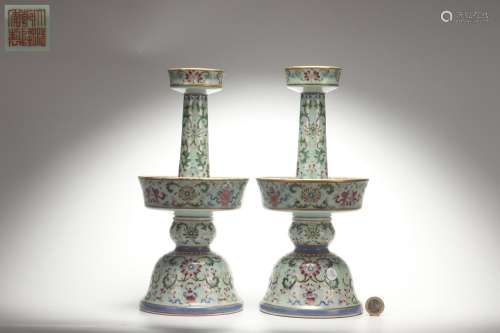 A Group Famille Rose Candlesticks with Interlaced Lotus Patt...