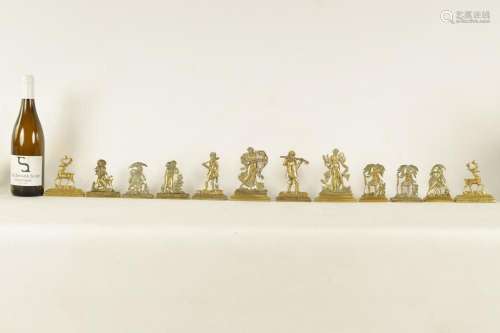 A GROUP OF SIX PAIRS OF 19TH CENTURY CAST BRASS HEARTH ORNAM...