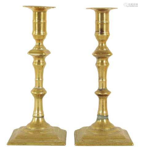 A PAIR OF EARLY GEORGE III CAST BRASS CANDLESTICKS