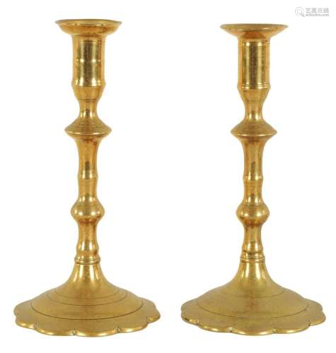 A PAIR OF EARLY GEORGE III CAST BRASS CANDLESTICKS