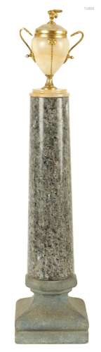 A 19TH CENTURY GRAND TOUR GRANITE AND ONYX URN TOPPED COLUMN