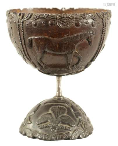 AN 18TH CENTURY CARVED COCONUT SHELL ON STAND