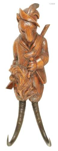 A LATE 19TH CENTURY BLACK FOREST CARVED LINDENWOOD COAT HOOK