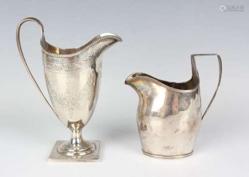 A late Victorian silver helmet shaped cream jug, engraved wi...