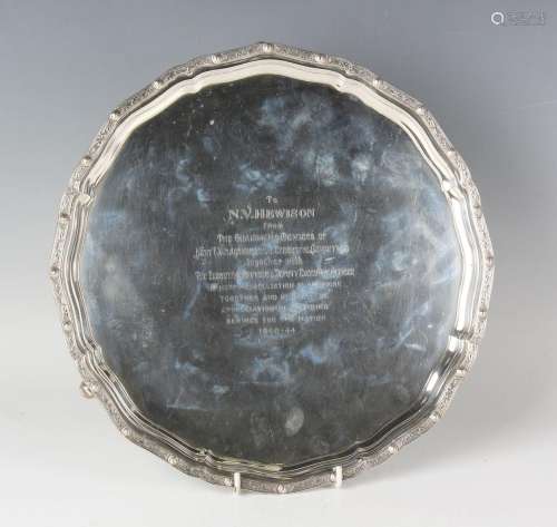 A George V silver circular salver, the raised rim cast with ...