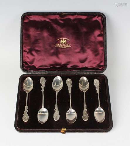 A set of six Victorian Rococo Revival silver teaspoons, each...