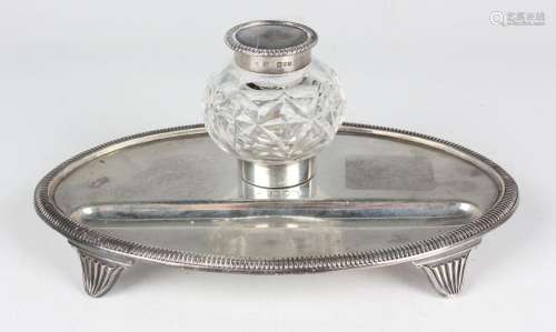 A late Victorian silver oval inkstand, fitted with a cut gla...