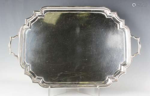 A George V silver tea tray of rectangular form with shaped c...