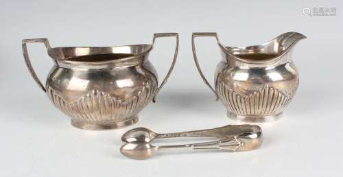A late Victorian silver half-reeded two-handled sugar bowl a...