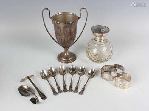 A George V silver twin-handled half-reeded trophy cup on a c...