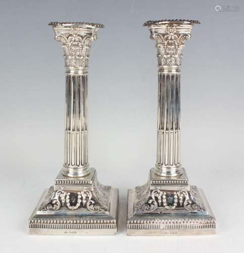 A pair of Edwardian silver Corinthian column candlesticks, e...