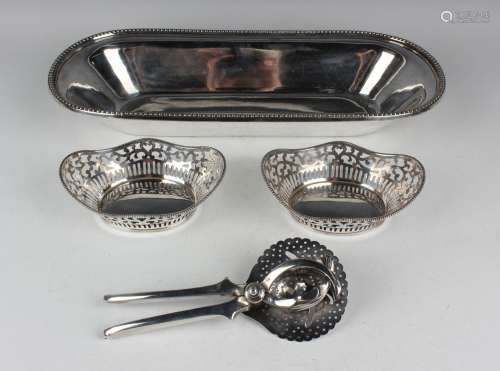 A pair of Elizabeth II silver oval sweetmeat baskets, each w...