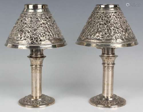 A pair of Cambodian silver candlesticks, each with cylindric...