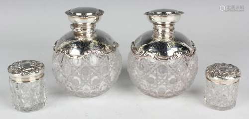 A pair of Edwardian silver mounted cut glass scent bottles a...