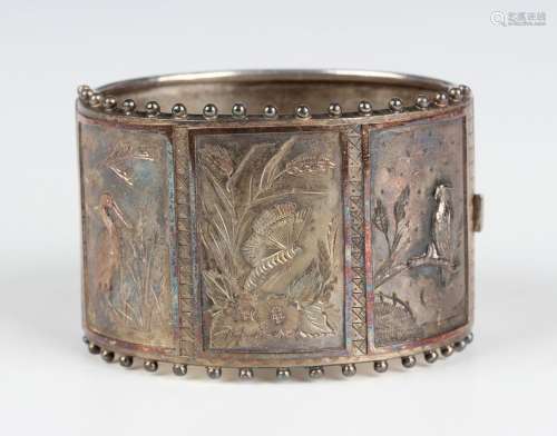 An Aesthetic silver wide oval hinged bangle, circa 1880, the...
