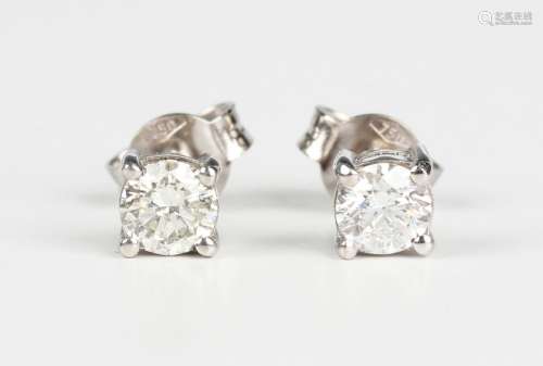 A pair of white gold and diamond single stone earstuds, each...