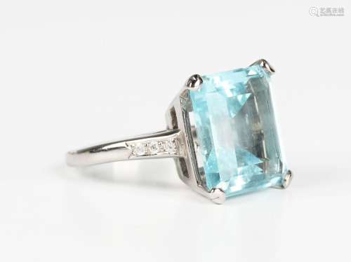 An aquamarine and diamond ring, claw set with the cut corner...