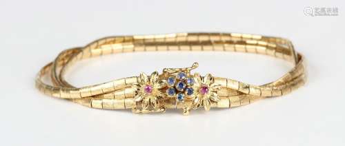 An Italian gold, ruby and sapphire bracelet in a triple row ...