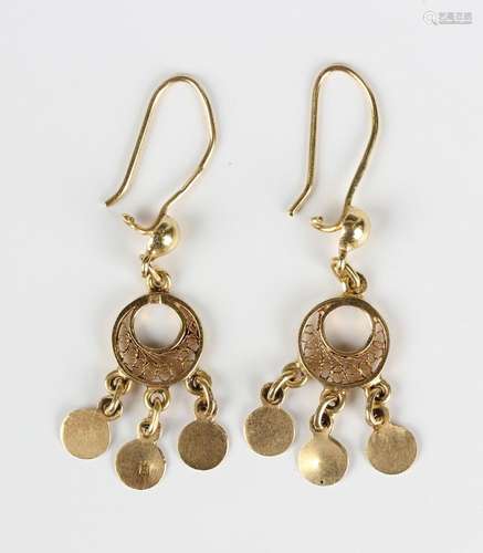 A pair of Egyptian gold earrings, each with three circular p...