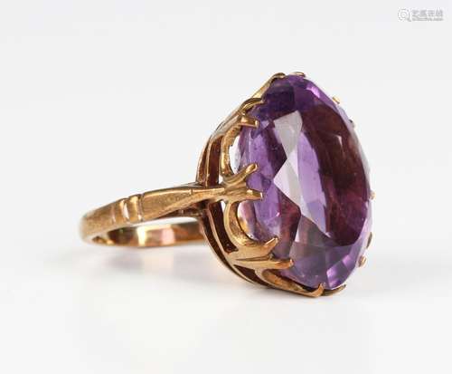 A 9ct gold ring, claw set with an oval cut amethyst, London ...