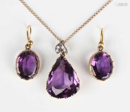 A gold, amethyst and diamond pendant, claw set with a drop s...