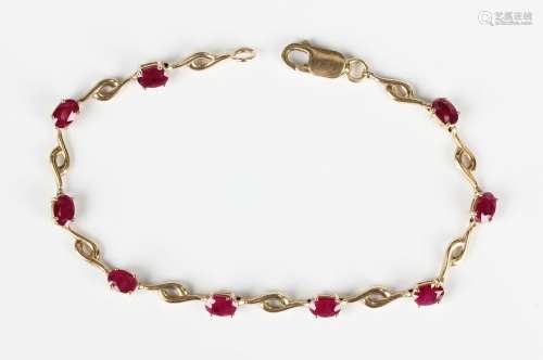 A 9ct gold and ruby bracelet, claw set with a row of nine ov...