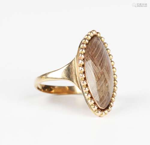 A gold marquise shaped ring, glazed with a woven hair locket...