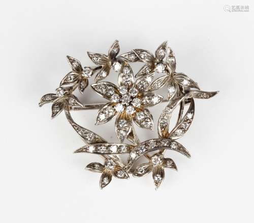 An 18ct white gold and diamond brooch in a floral and foliat...