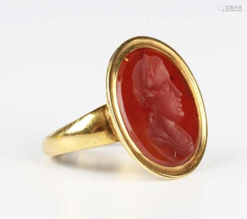 A gold and cornelian intaglio ring, the large oval cornelian...