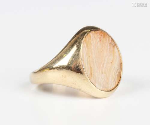 A gold and agate intaglio ring, the oval agate carved with a...