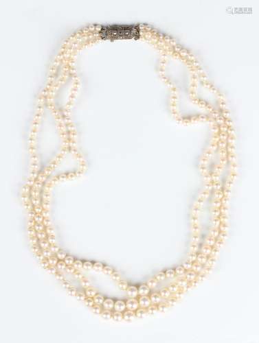 A three row necklace of graduated cultured pearls on a silve...