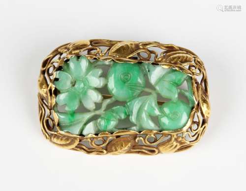 A gold and carved jade brooch, 1930s, the central jade carve...