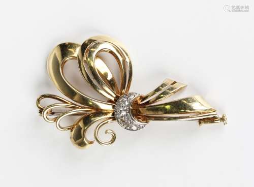 A gold and diamond brooch in an entwined scrolling design wi...