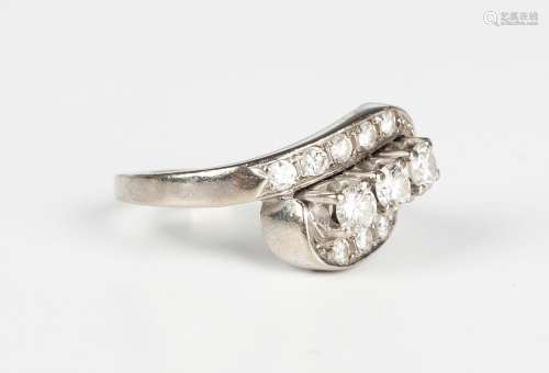 A white gold and diamond ring in a twistover design, claw se...