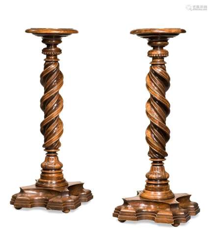 A PAIR OF ITALIAN CARVED WALNUT TORCHERES, IN 17TH CENTURY S...