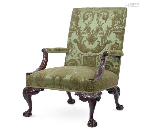 A CARVED MAHOGANY AND UPHOLSTERED GAINSBOROUGH ARMCHAIR, IN ...