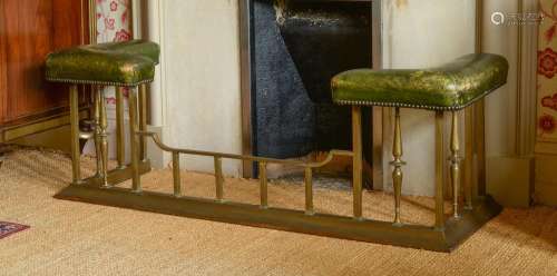 A BRASS AND STUDDED GREEN LEATHER UPHOLSTERED CLUB FENDER, 2...