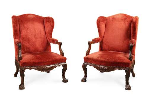 A PAIR OF CARVED WALNUT AND UPHOLSTERED WING ARMCHAIRS, IN I...