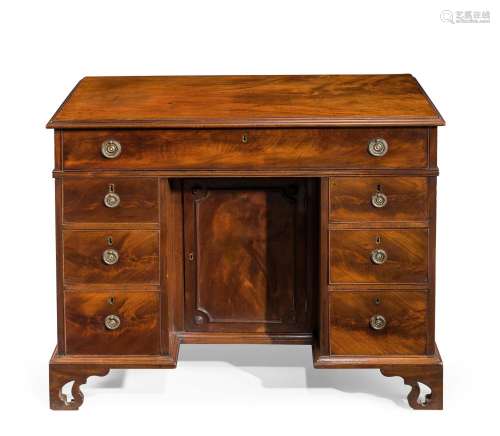 A GEORGE III MAHOGANY KNEEHOLE DESK, IN THE MANNER OF THOMAS...