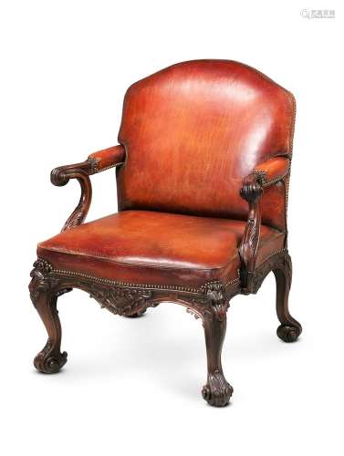 A CARVED MAHOGANY AND LEATHER UPHOLSTERED OPEN ARMCHAIR, IN ...