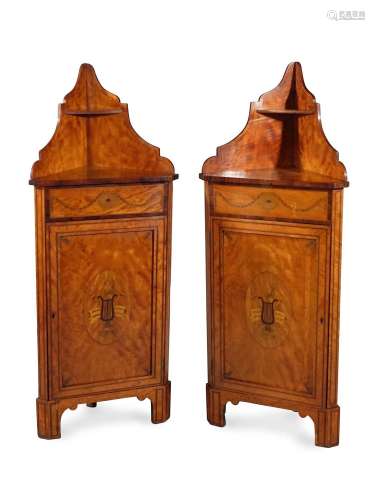 Y A PAIR OF SATINWOOD AND MARQUETRY STANDING CORNER CABINETS...