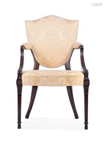 A CARVED MAHOGANY AND SILK DAMASK UPHOLSTERED ELBOW CHAIR, B...