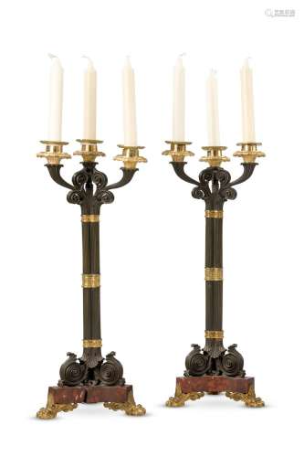 A PAIR OF GILT AND PATINATED CLUSTER COLUMN THREE LIGHT CAND...