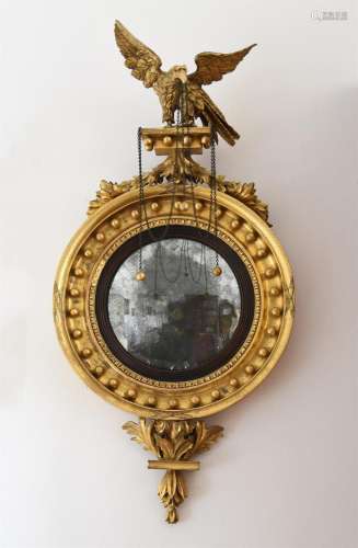 A REGENCY GILTWOOD CONVEX WALL MIRROR, CIRCA 1820