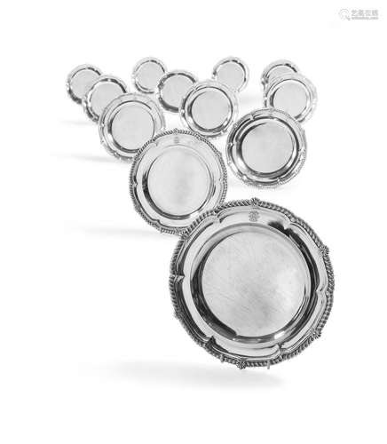 A GEORGE III SET OF TWELVE SILVER SHAPED CIRCULAR PLATES, PA...